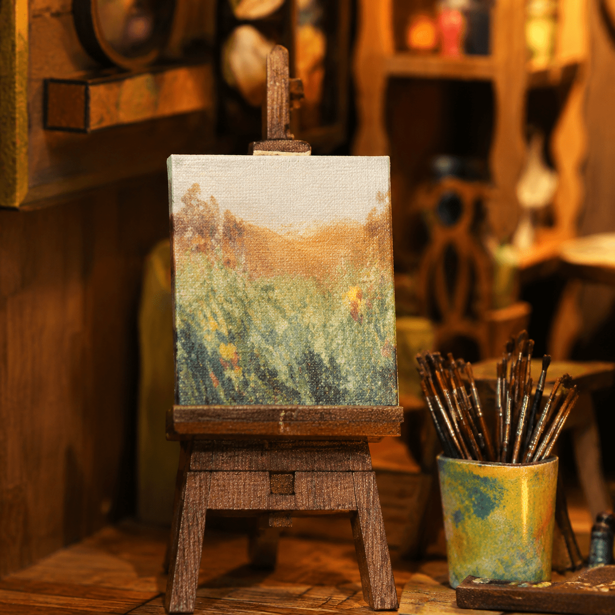 Art Gallery Book Nook Miniatur mit Staffelei, Landschaftsgemälde, Pinseln und detailreicher Künstleratelier-Szene