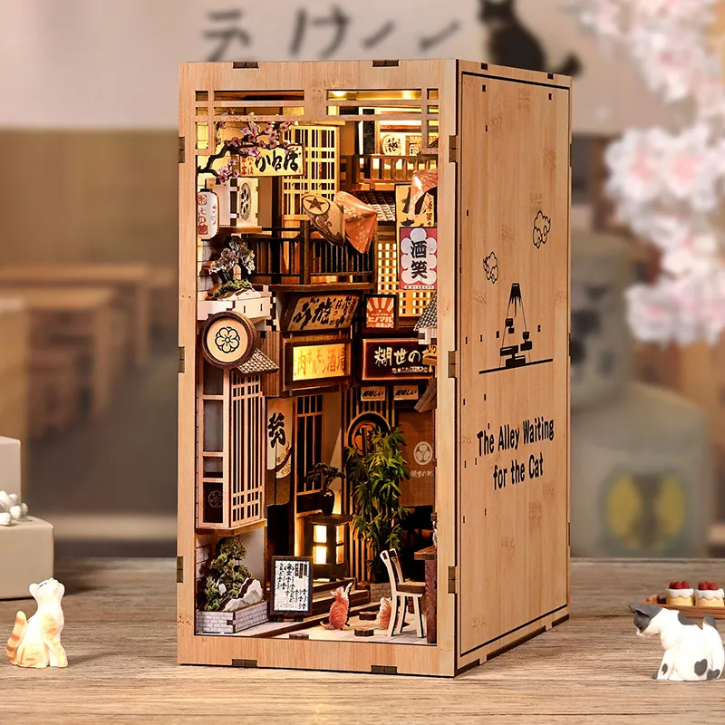 Japanese Alley Cat Book Nook with a miniature street scene, warm lighting, and a cat in a cozy bookshelf setting